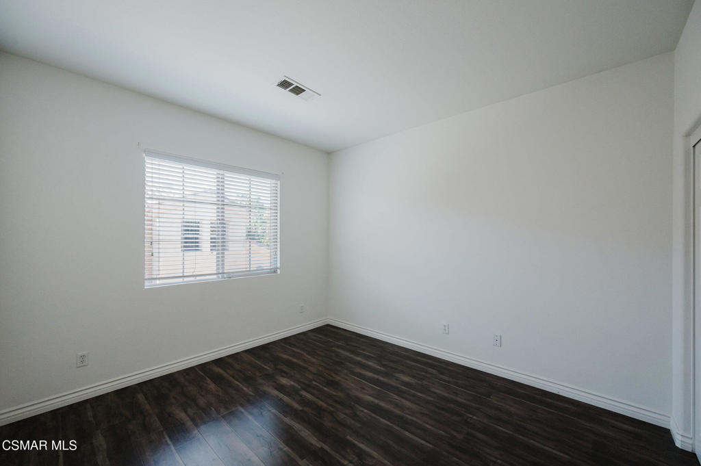 1454 Patricia Avenue, Unit 402 Simi Valley, CA 93065 - Photo 40 of 50 an empty room with wooden floor and windows