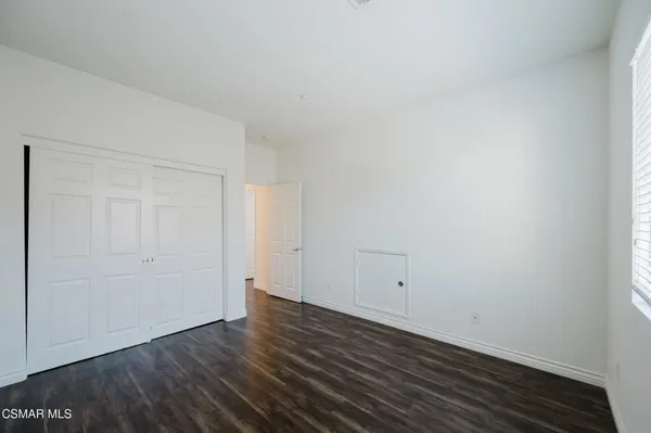 a view of room with wooden floor