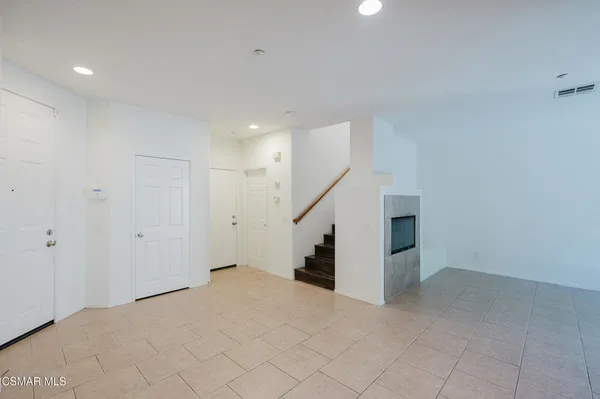 a view of an empty room with stairs