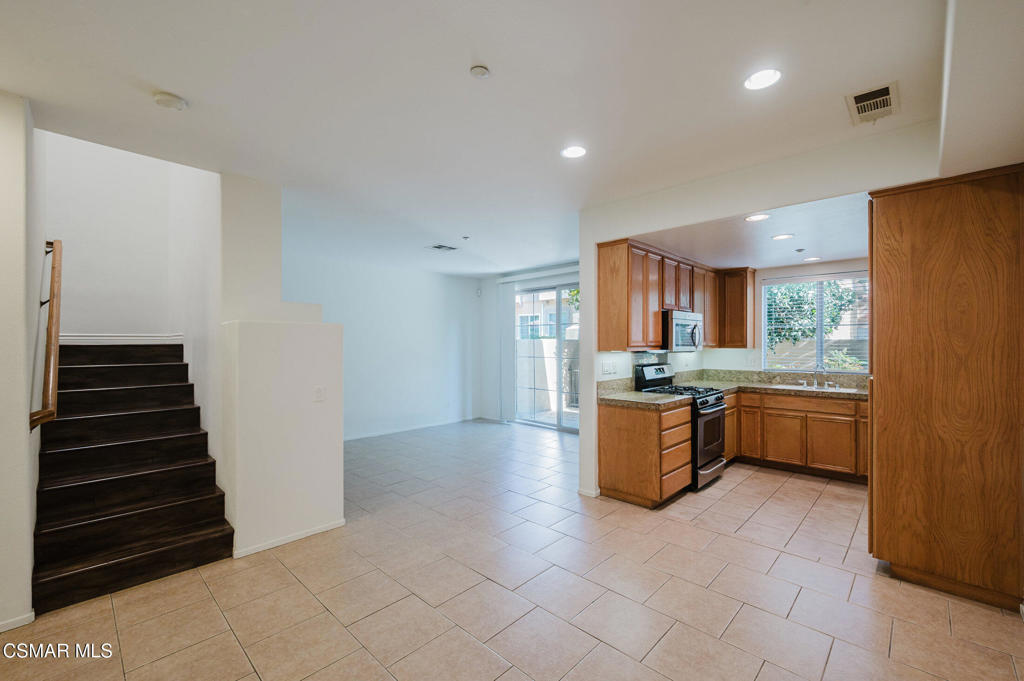 1454 Patricia Avenue, Unit 402 Simi Valley, CA 93065 - Photo 7 of 50 a kitchen with a refrigerator and a sink