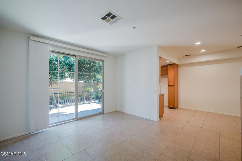 1454 Patricia Avenue, Unit 402 Simi Valley, CA 93065 - Photo 8 of 50 a view of an empty room with wooden floor and a window