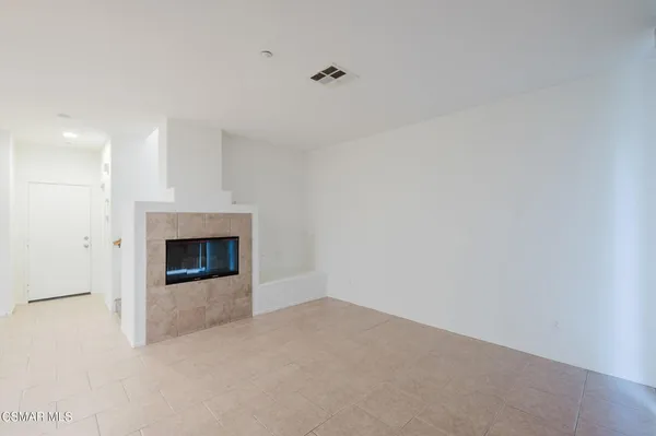 a view of an empty room with a fireplace