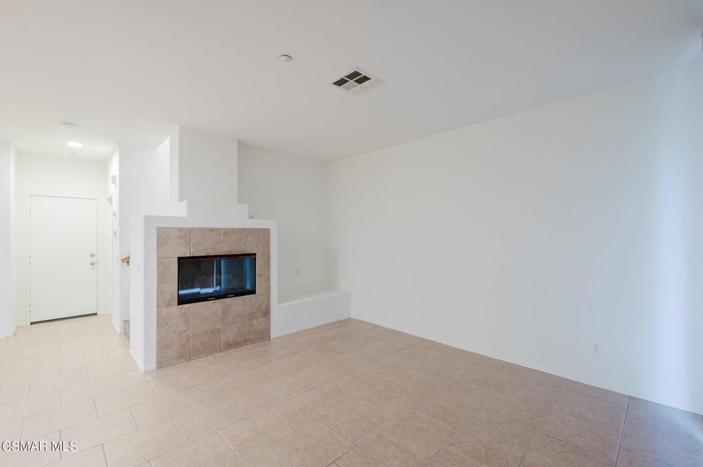 1454 Patricia Avenue, Unit 402 Simi Valley, CA 93065 - Photo 9 of 50 a view of an empty room with a fireplace