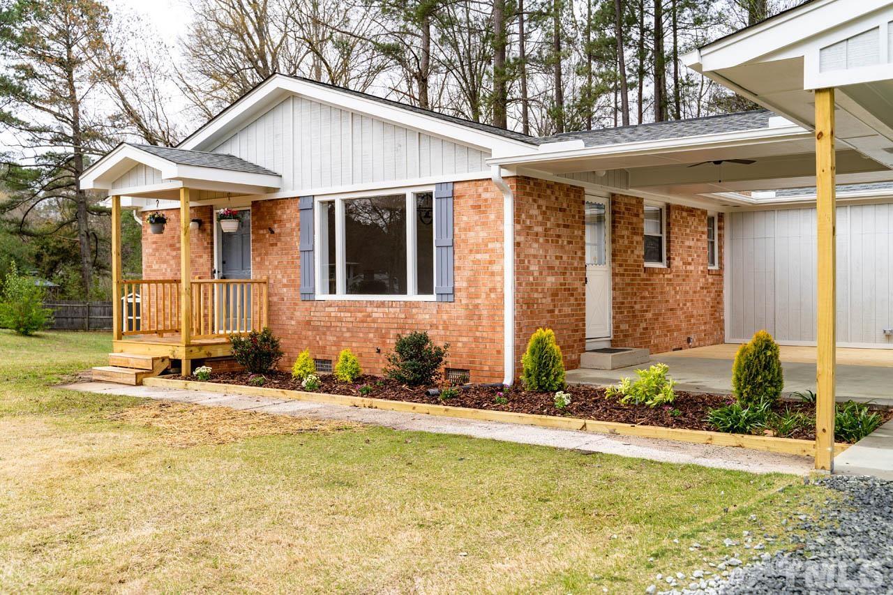 8 Holmes Circle Durham, NC 27713 - Photo 1 of 20 a front view of a house with a yard outdoor seating and garage