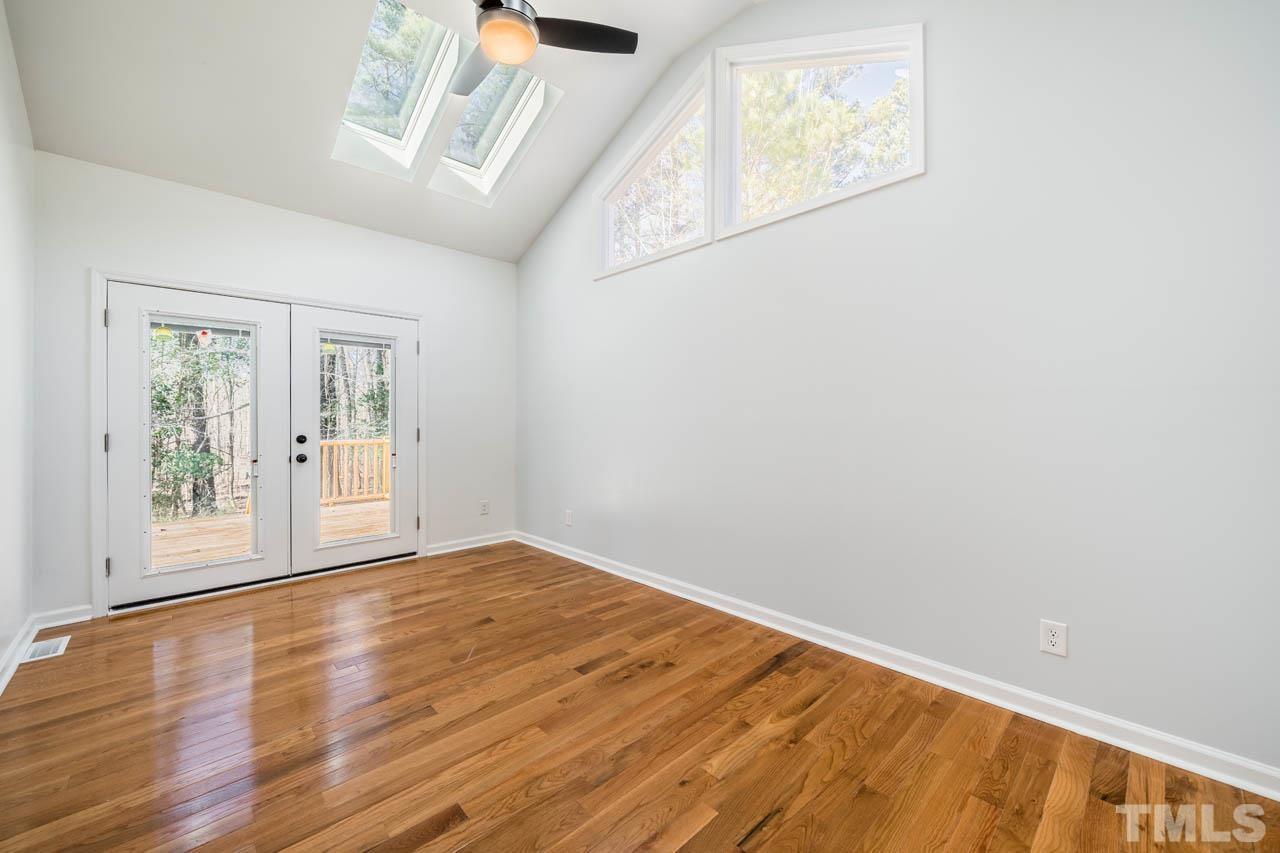 8 Holmes Circle Durham, NC 27713 - Photo 14 of 20 a view of an empty room with wooden floor and a window