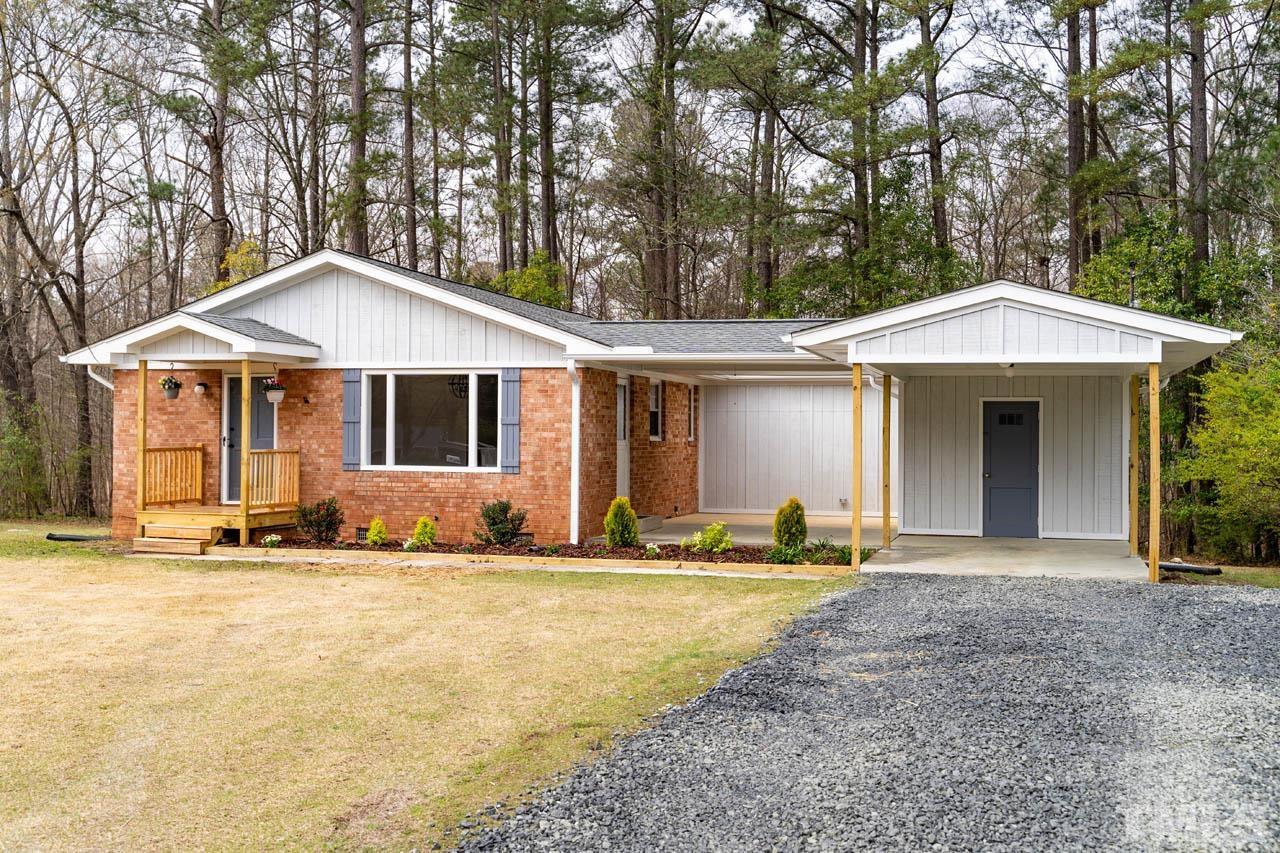 8 Holmes Circle Durham, NC 27713 - Photo 2 of 20 a front view of a house with a garden and trees