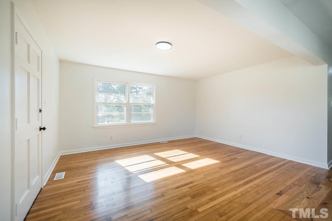 8 Holmes Circle Durham, NC 27713 - Photo 4 of 20 a view of empty room with wooden floor and fan