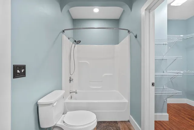 a bathroom with a toilet and a shower