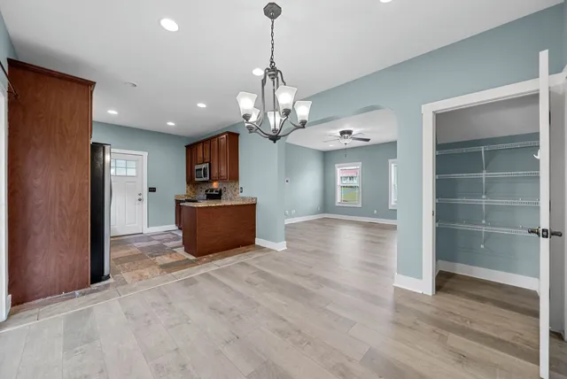 a view of a kitchen with a sink and a chandelier kitchen view