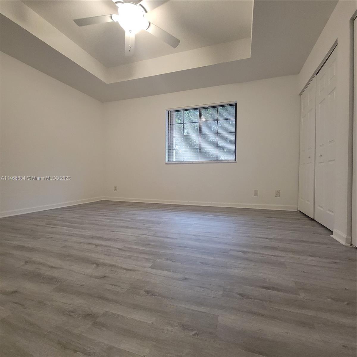 3883 Tree Top Drive Weston, FL 33332 - Photo 14 of 22 an empty room with wooden floor and windows