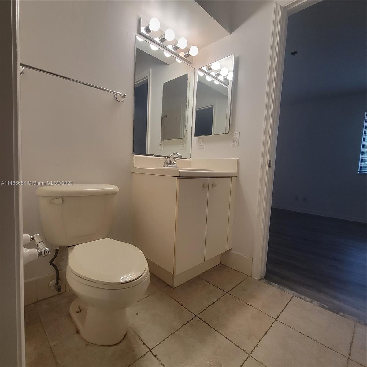 3883 Tree Top Drive Weston, FL 33332 - Photo 18 of 22 a bathroom with a toilet a sink and mirror