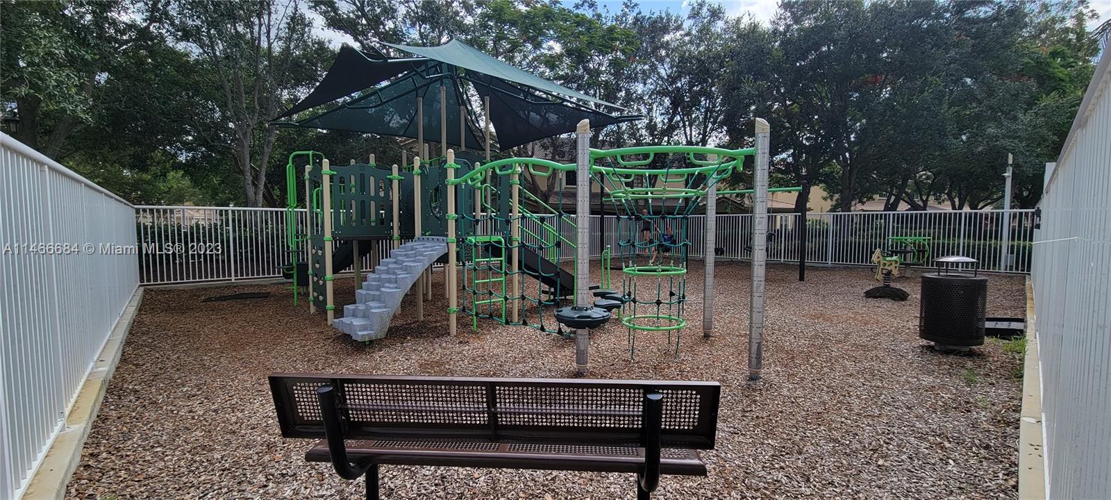 3883 Tree Top Drive Weston, FL 33332 - Photo 20 of 22 a view of a bench in a backyard