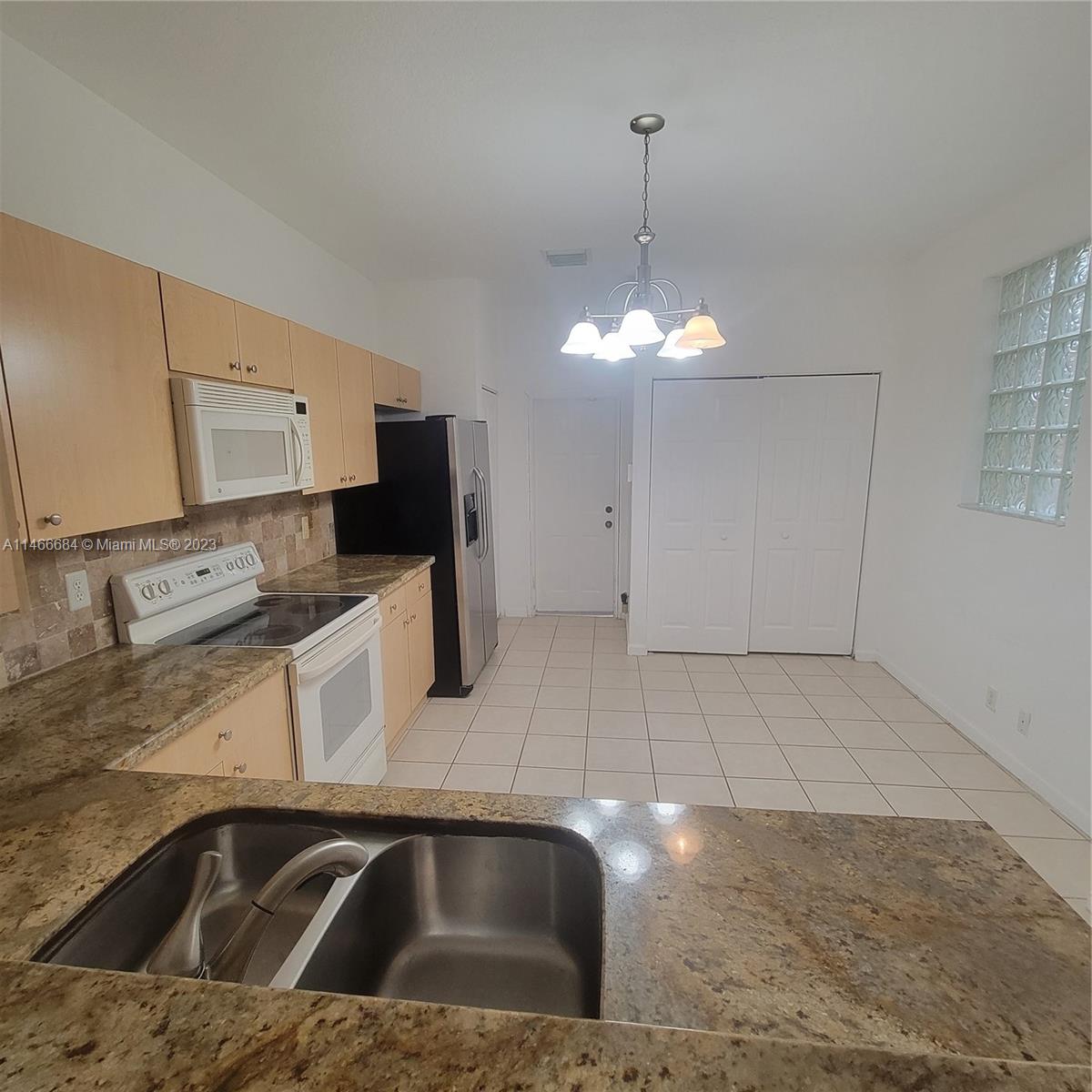 3883 Tree Top Drive Weston, FL 33332 - Photo 5 of 22 a kitchen with a sink and cabinets