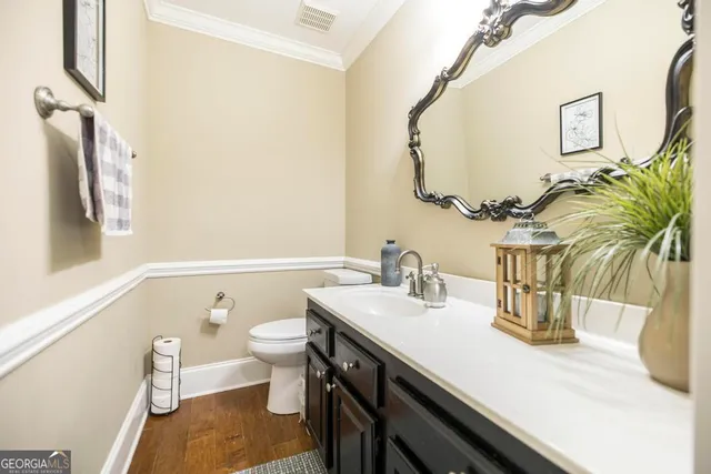 a bathroom with a sink a toilet and mirror