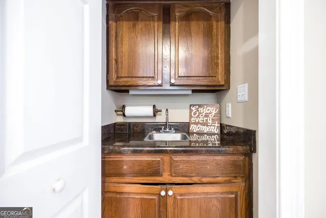 a kitchen with granite countertop white cabinets and stainless steel appliances