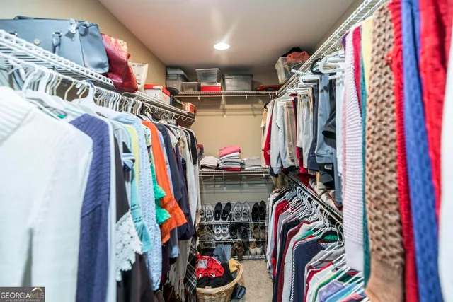 a view of walk in closet with clothes
