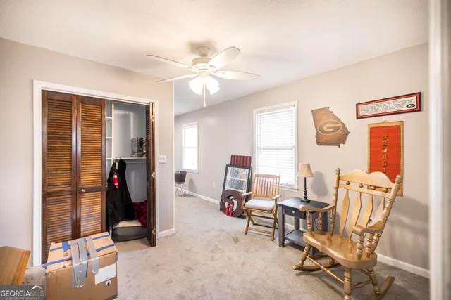 a view of a livingroom with furniture and a window