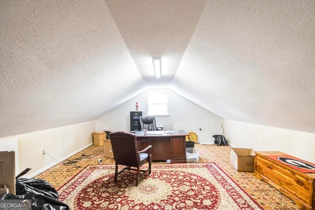 a living room with furniture rug and a table