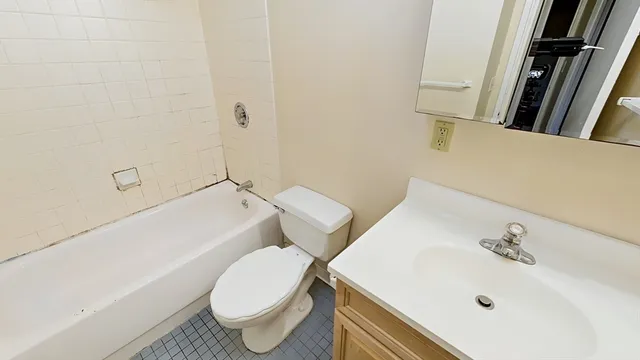 a bathroom with a sink a toilet and bathtub