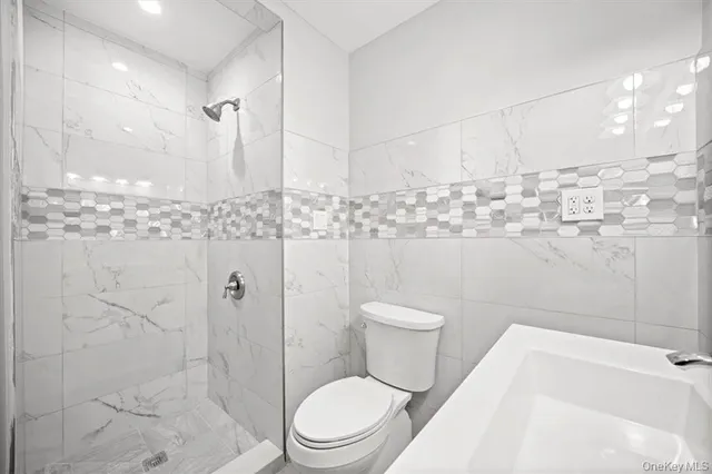 a bathroom with a toilet sink and shower