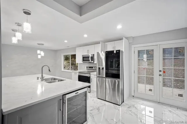a view of kitchen with center island wooden floor and windows