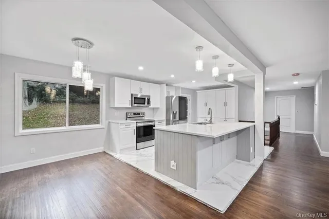 a kitchen with stainless steel appliances a refrigerator and a sink