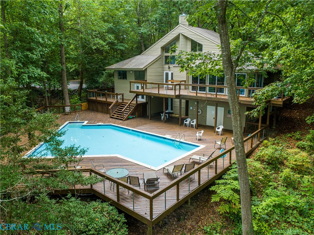 54 Villa Ridge Drive, Unit C Hartfield, VA 23071 - Photo 30 of 45 Community pool with stairway and a deck