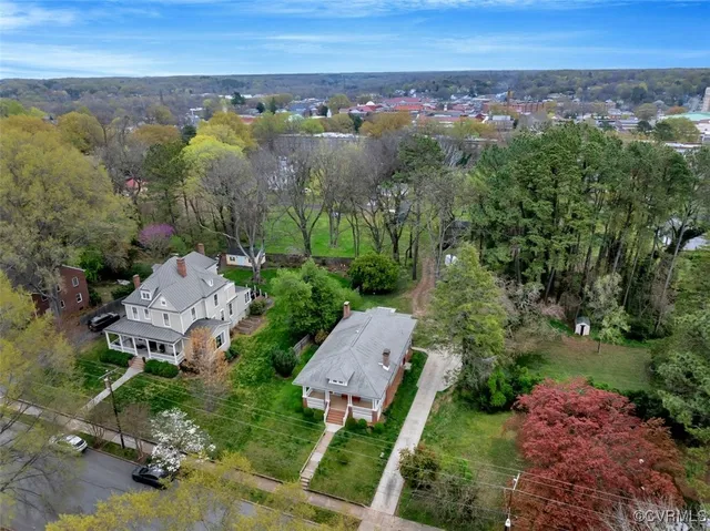 an aerial view of a house with a yard