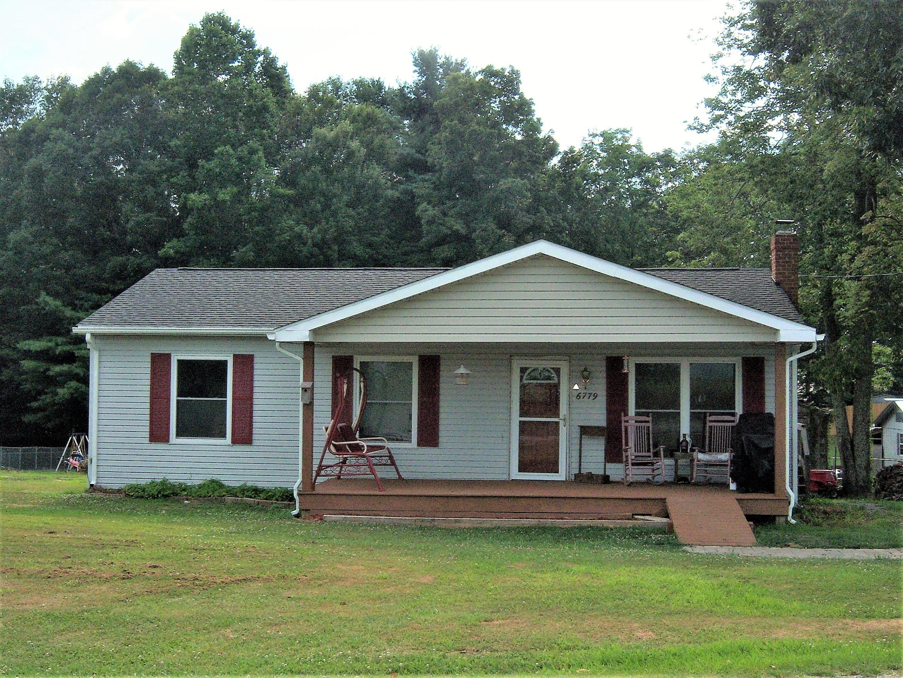 6779 Conner Road Northeast Copper Hill, VA 24079 - Photo 1 of 18 a view of a house with a yard potted plants and large tree