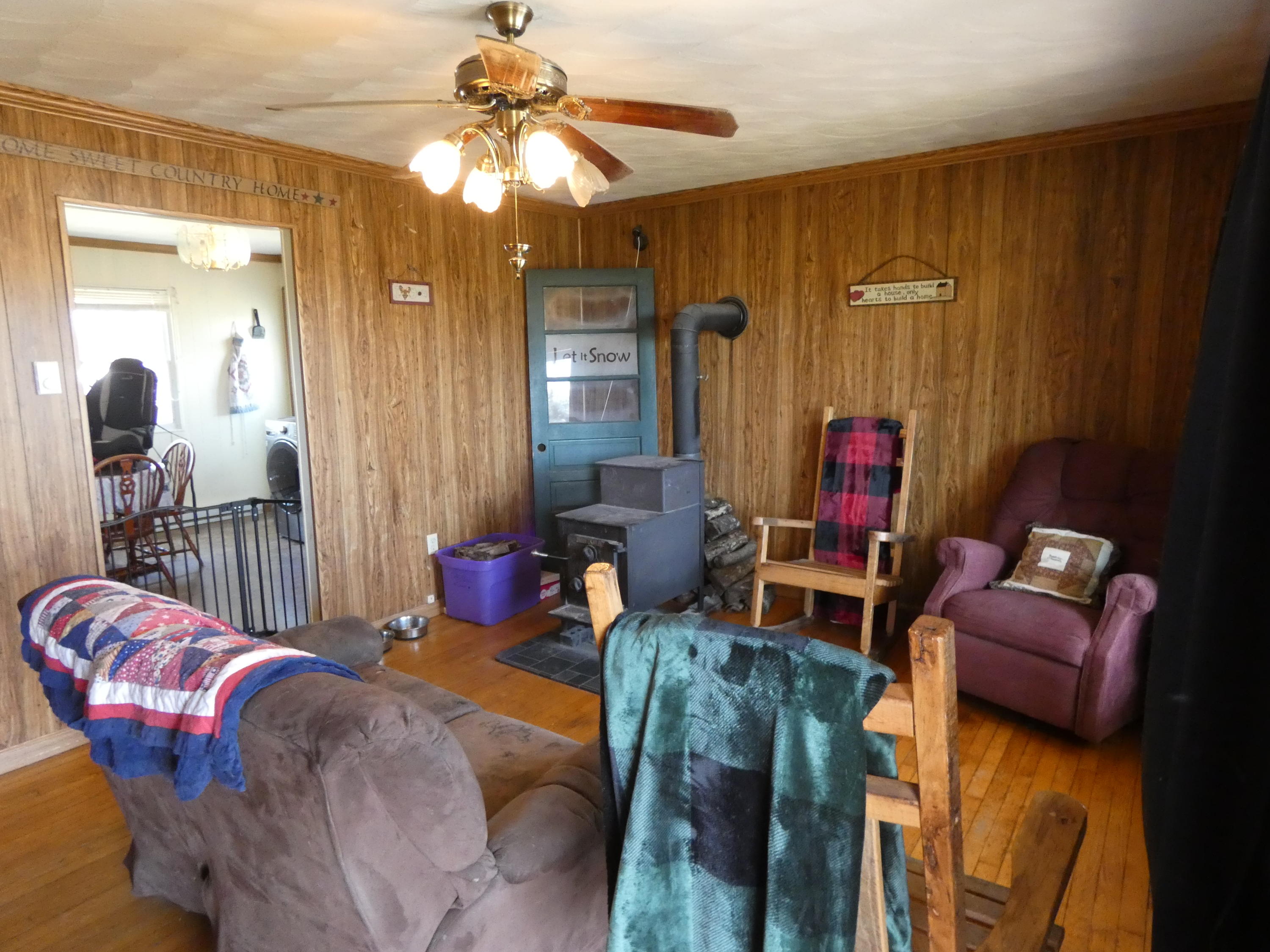6779 Conner Road Northeast Copper Hill, VA 24079 - Photo 15 of 18 a living room with furniture a chandelier and a wooden floor