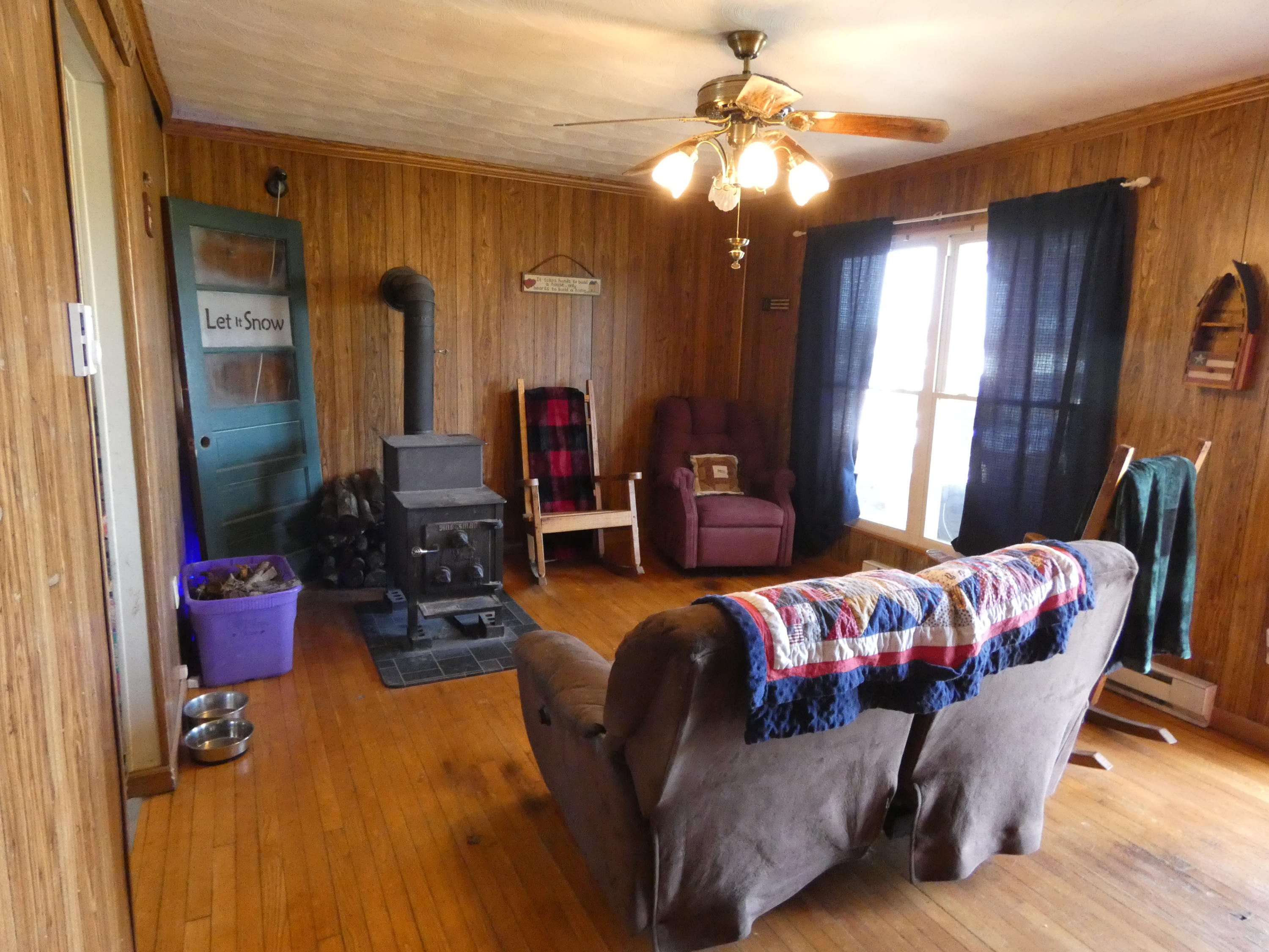 6779 Conner Road Northeast Copper Hill, VA 24079 - Photo 16 of 18 a living room with furniture a chandelier and a window