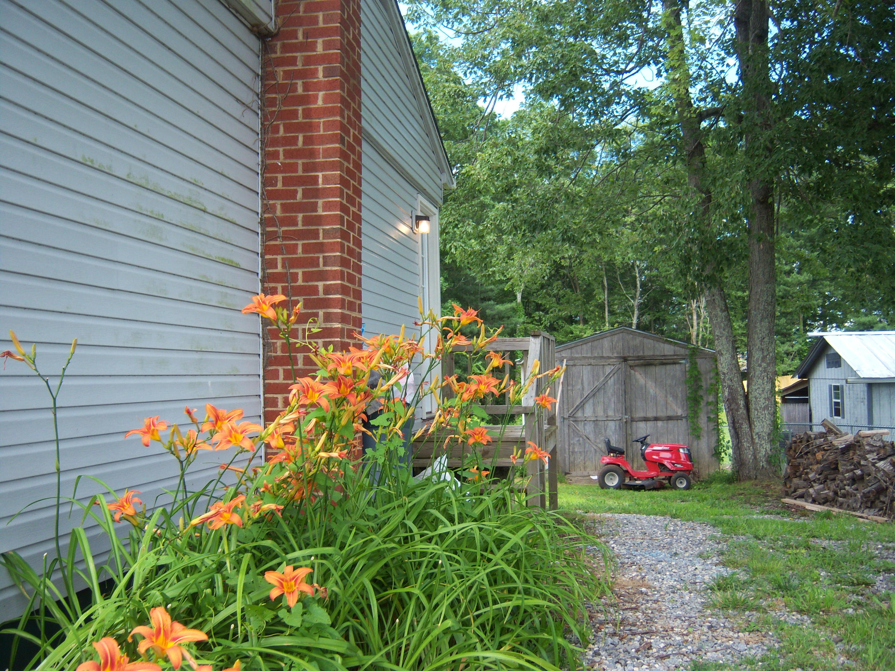 6779 Conner Road Northeast Copper Hill, VA 24079 - Photo 17 of 18 a backyard of a house with lots of green space and fountain