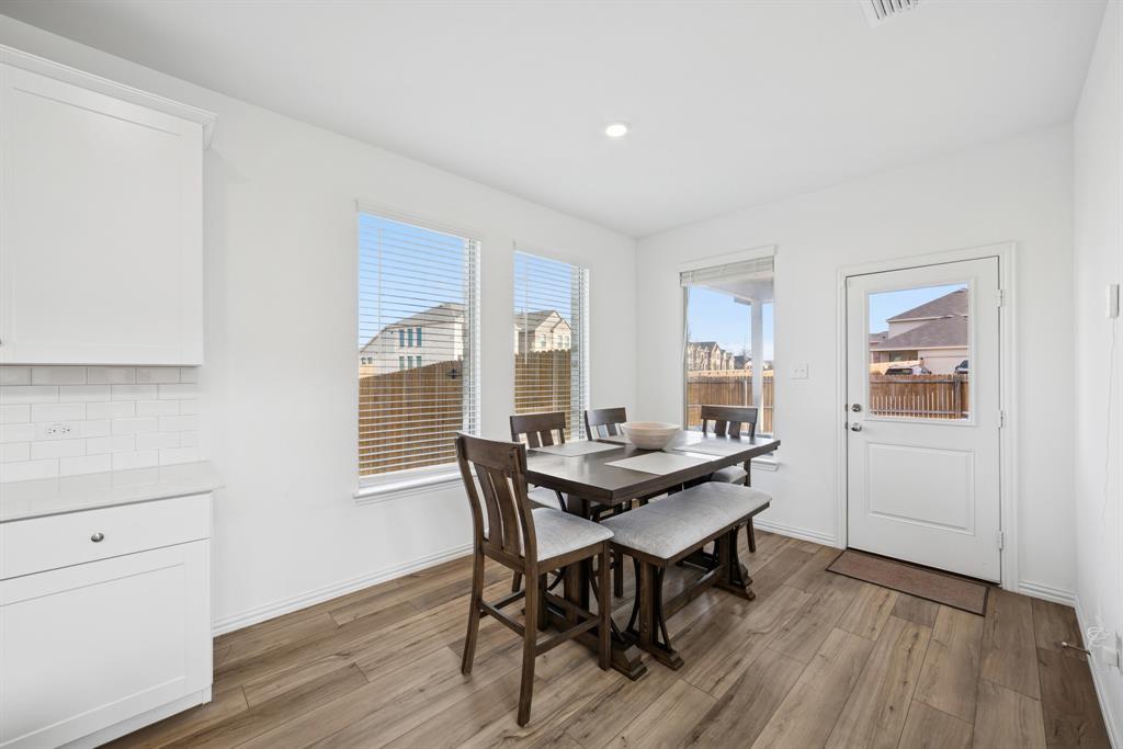 10040 Thornapple Road Fort Worth, TX 76179 - Photo 10 of 24 a view of a dining room with furniture and wooden floor