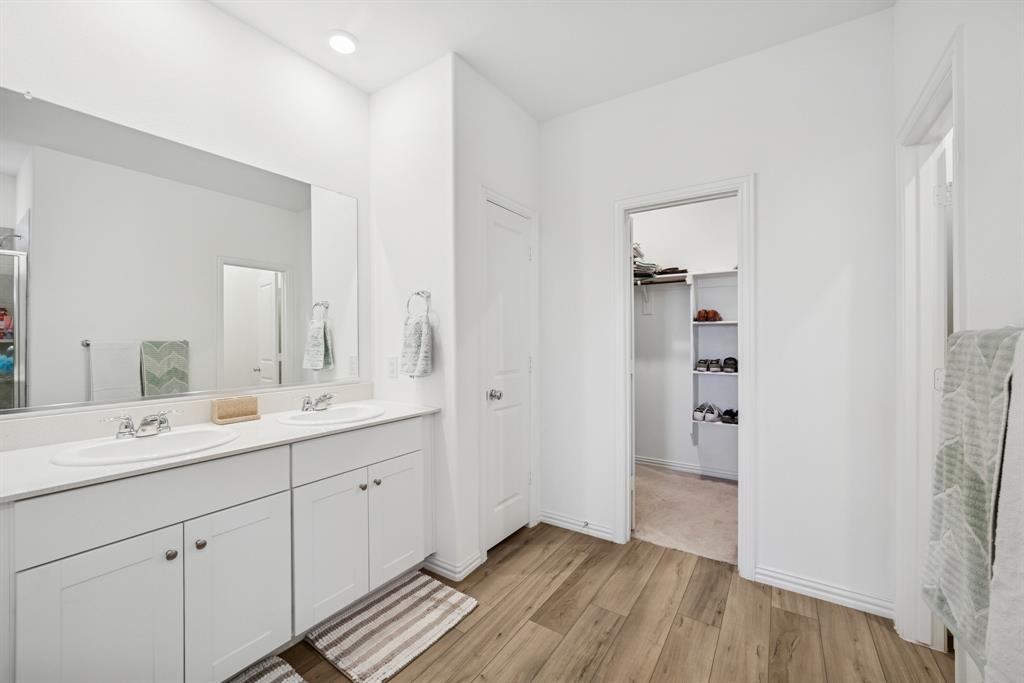 10040 Thornapple Road Fort Worth, TX 76179 - Photo 12 of 24 a spacious bathroom with a double vanity sink a mirror and a shower