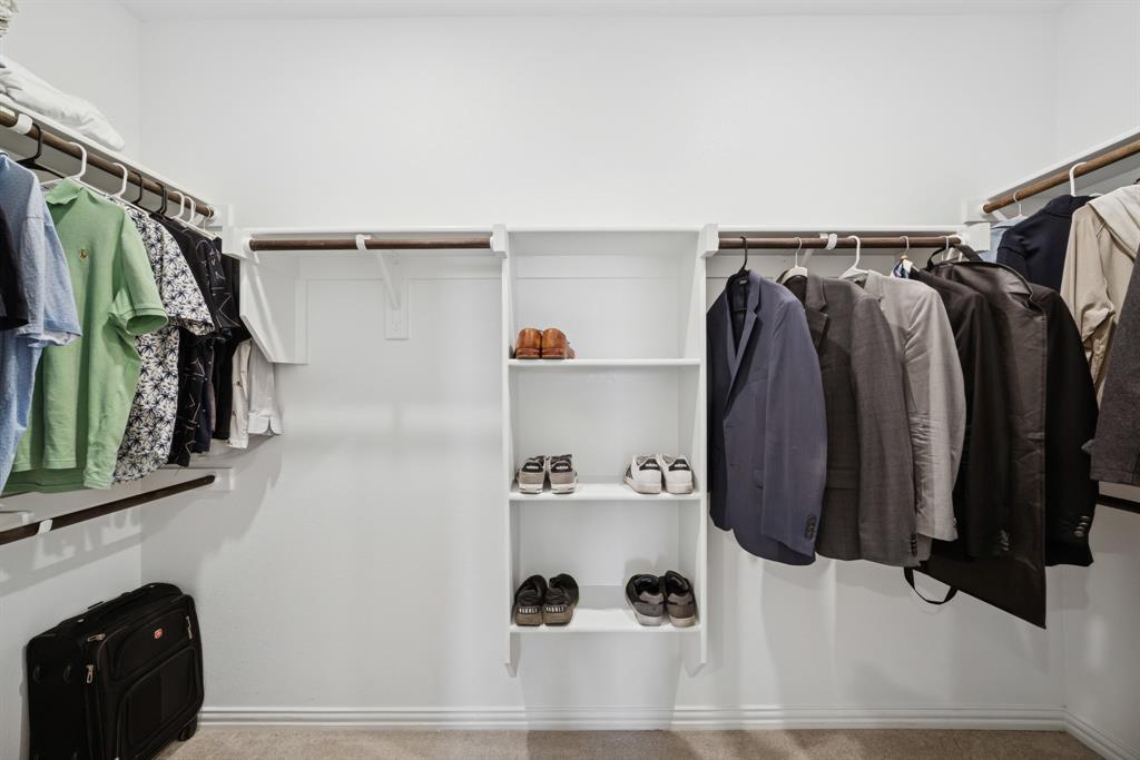 10040 Thornapple Road Fort Worth, TX 76179 - Photo 13 of 24 a view of walk in closet with clothes and shoes