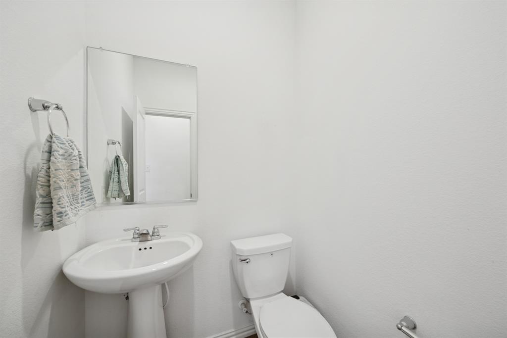 10040 Thornapple Road Fort Worth, TX 76179 - Photo 14 of 24 a bathroom with a toilet sink and mirror