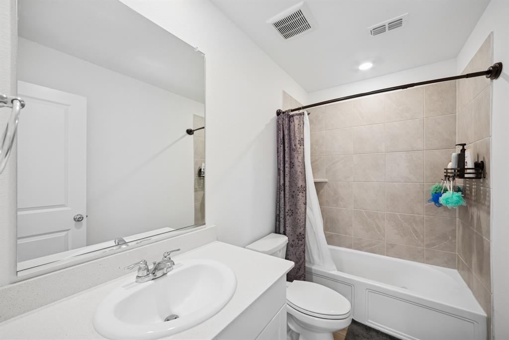 10040 Thornapple Road Fort Worth, TX 76179 - Photo 18 of 24 a bathroom with a sink toilet and shower