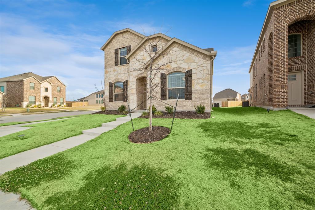 10040 Thornapple Road Fort Worth, TX 76179 - Photo 22 of 24 a front view of a house with garden