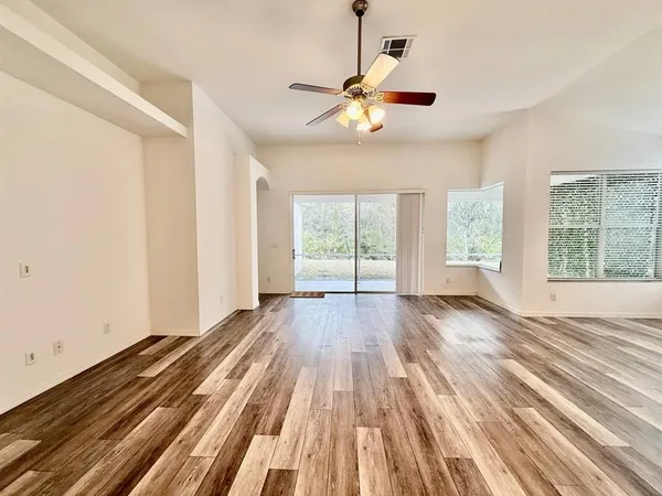 wooden floor in an empty room with a window