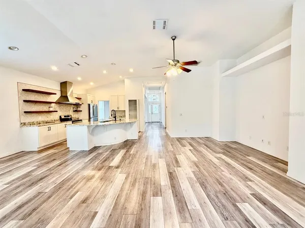 a view of a kitchen with wooden floor