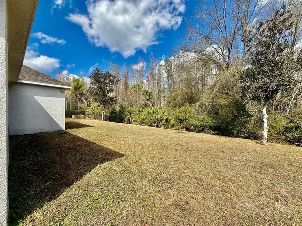 a front view of house with yard and trees around