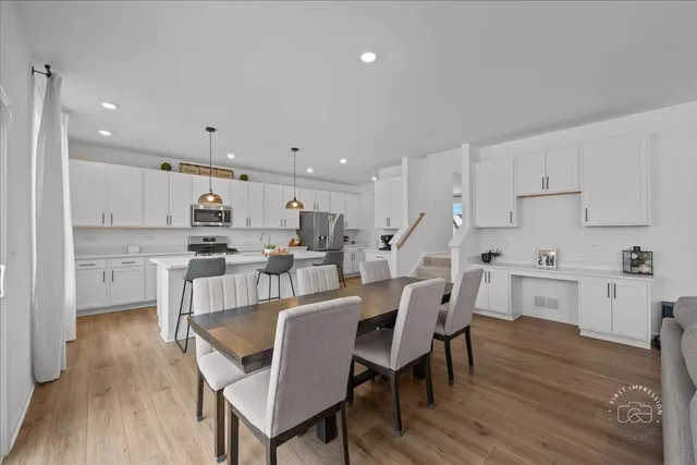 a view of kitchen with cabinets table and chairs