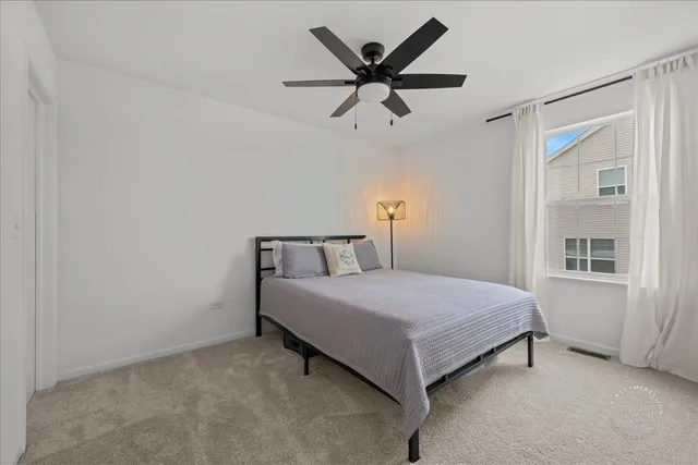 a bedroom with a bed and window