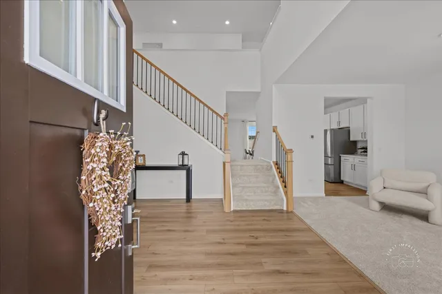 a view of entryway and hall with wooden floor