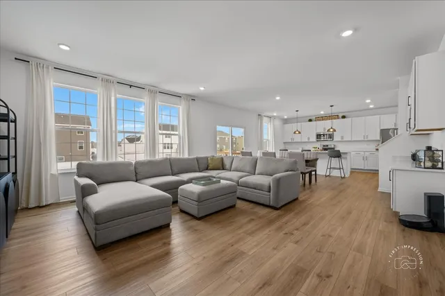 a living room with furniture and a large window
