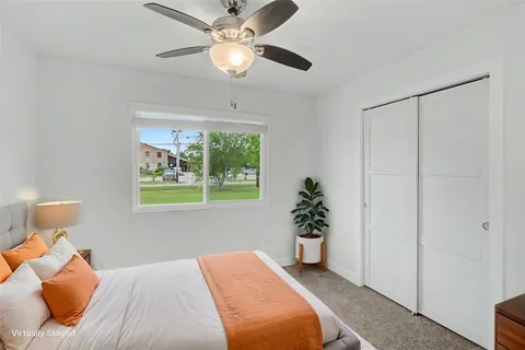 a bedroom with a bed and a potted plant