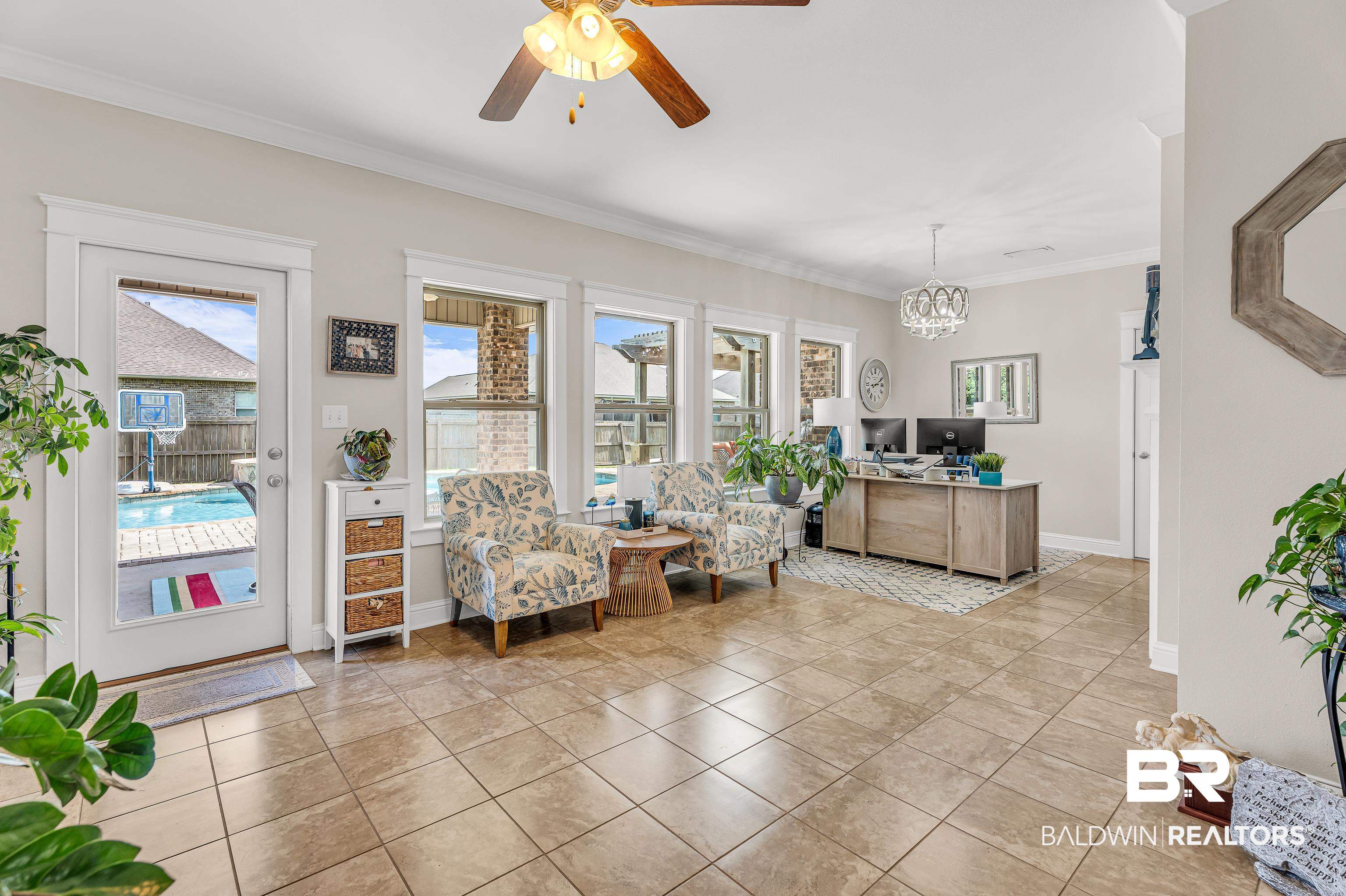 9675 Camberwell Drive Daphne, AL 36526 - Photo 15 of 34 Sitting room featuring a ceiling fan, crown molding, a chandelier, and light tile patterned floors