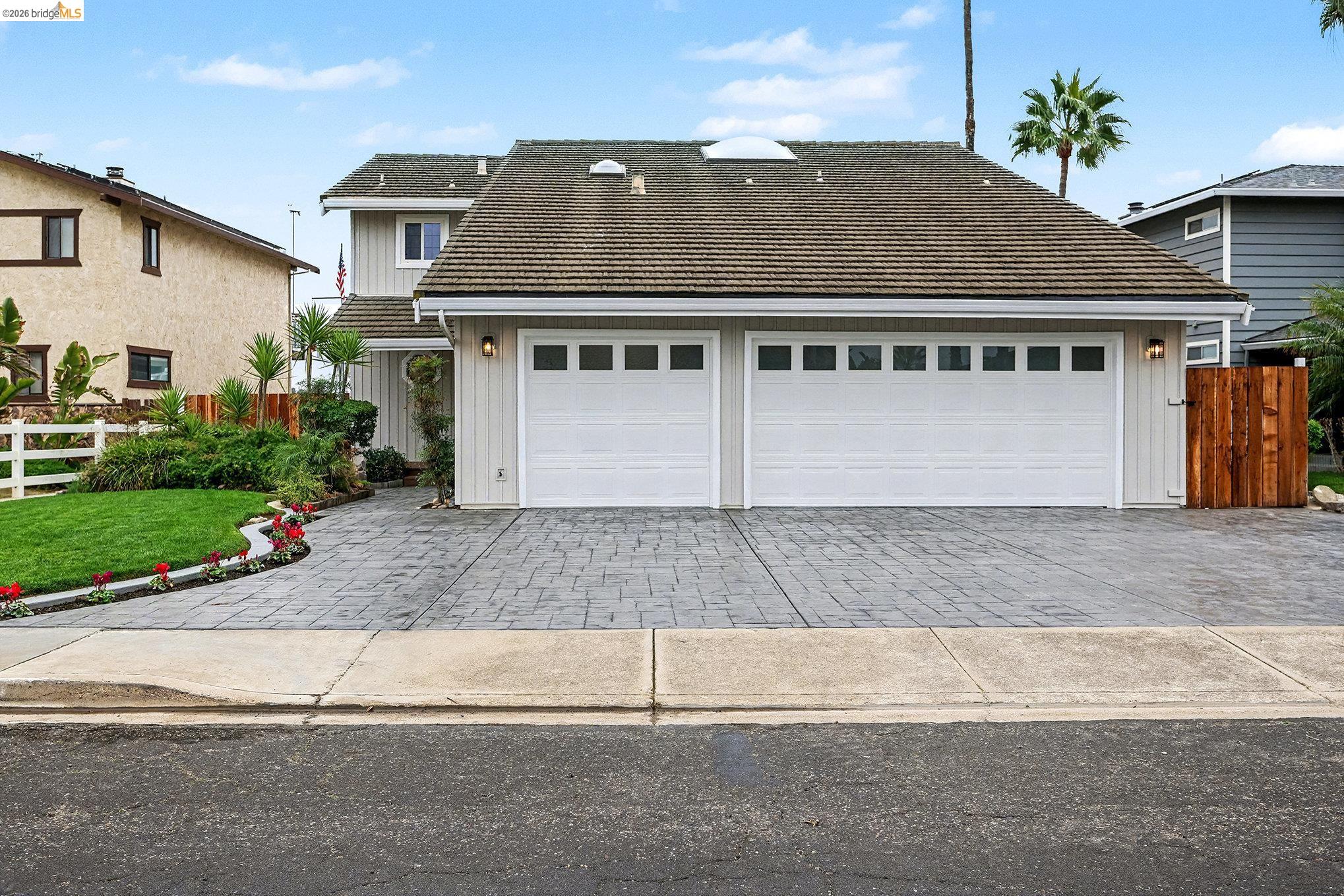 4741 Discovery Point Discovery Bay, CA 94505 - Photo 2 of 52 a front view of a house with a yard and garage