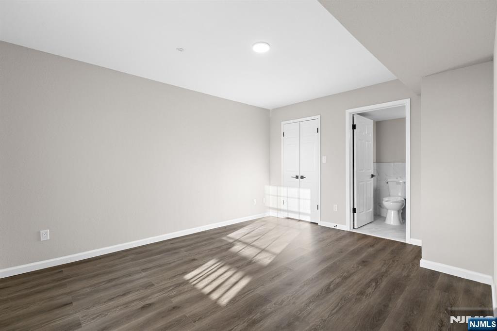 690 Rt 23, Unit R3 Wayne, NJ 07470 - Photo 7 of 11 a view of an empty room with wooden floor and closet