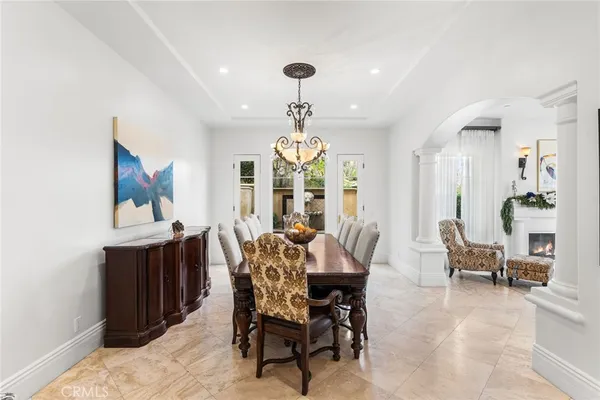 a view of a dining room with furniture and chandelier